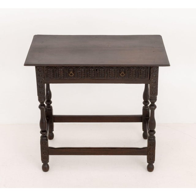 Spanish Baroque Style Oak Side Table, with carved foliate motif to single drawer above four turned wood legs conjoined by...