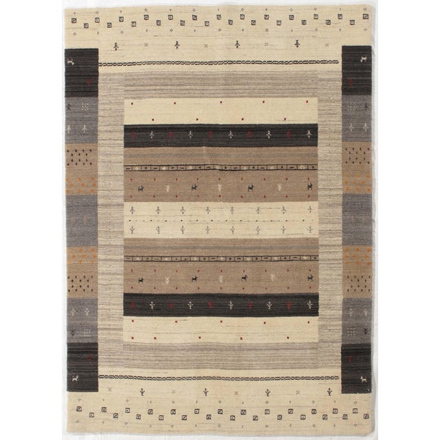 Hand-knotted Indo-Gabbeh wool rug with a rectangular field composed of horizontal bands in ivory, taupe, gray, and...