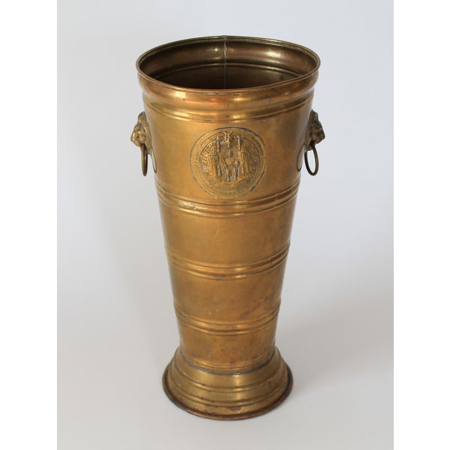 Vintage brass lion head umbrella stand/holder with intricate medallion. No makers mark. Overall age wear. Small dents,...