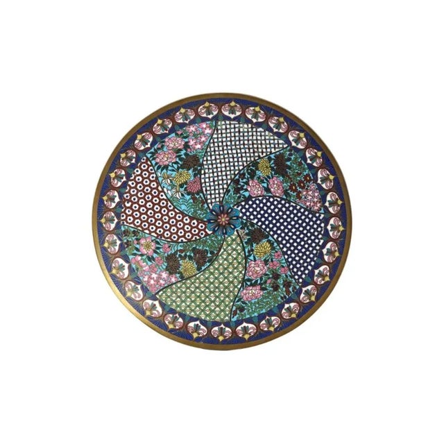 An antique Japanese Meiji era decorative enamel over copper plate. The plate is made in a swirl panel design. The panels...