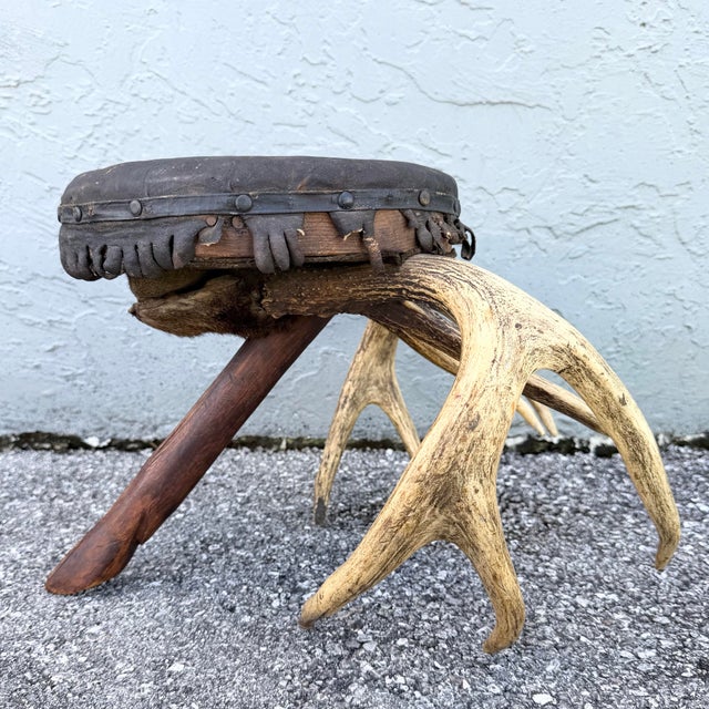 This early 20th century American rustic footstool captures the spirit of the great outdoors with remarkable handcrafted...
