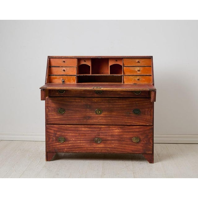 Genuine antique Swedish country house secretary chest from around 1820 to 1830. The secretary has a writing desk and...