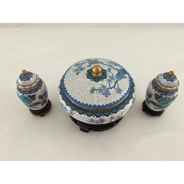 Mid-Century Modern Cloisonné ginger jars and lidded bowl in various shades of blue, green and black. All on wood stands....