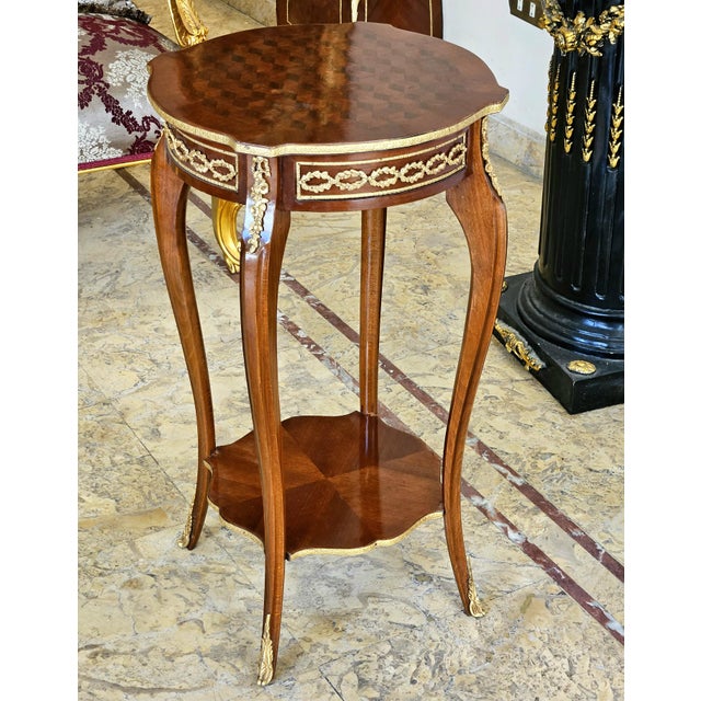 This French style wood side table is a luxurious statement piece that brings timeless elegance and refined craftsmanship...
