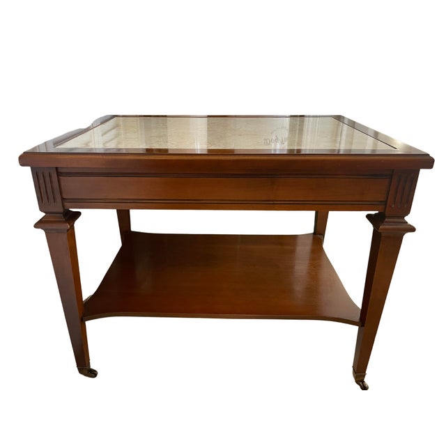 Mid 20th century walnut wooden end tables with marble top and brass casters. One rectangular and one square. Rectangular...