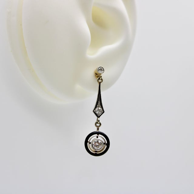 These gorgeous 18k gold Art Deco earrings begin with an Old European cut diamond, surrounded by platinum and milgrain...