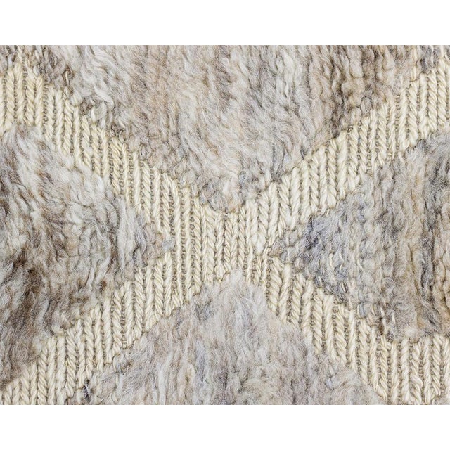 Hand-knotted rug with a blend of Sand, Taupe, and Ivory hues in a distinctive diamond design, crafted from wool for...
