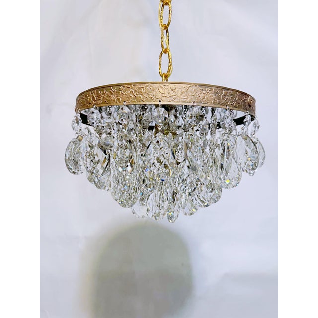 Bring romance and vintage texture to your home with this enchanting mid-century tiered brass rim and Swedish crystal drops...