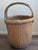 Hand woven of willow reeds with a triple hand carved bamboo handle and ring. The ring is wrapped with rattan. The handle...