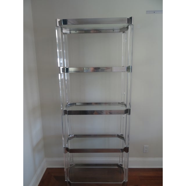 Stunning and Timeless Lucite etagere designed by Charles Hollis Jones. The lucite is joined with polished stainless steel...