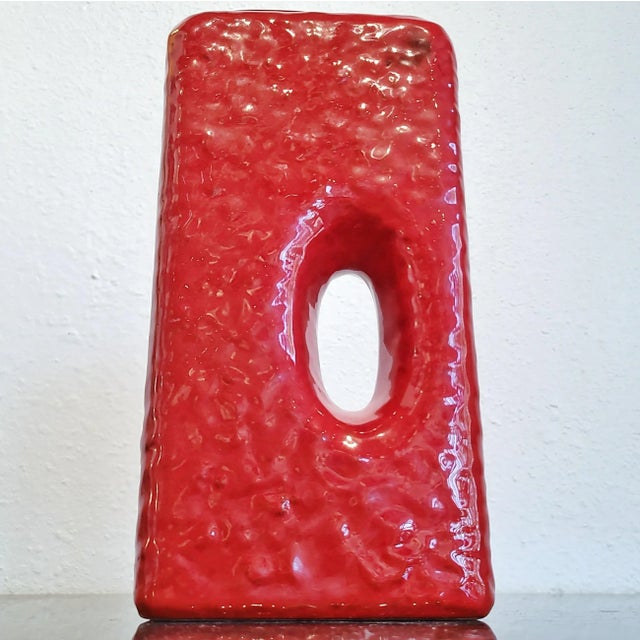 A heavy-duty MAREI KERAMIK chimney vase with a lumpy fat lava glaze in glossy red. Form Nr. 2004. Produced in the 1970s....