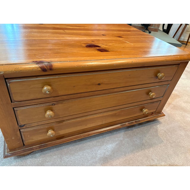 It's a large square coffee table with 3 drawers on each side. It measures 36" square and 19" high. It was manufactured by...
