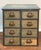 A nicely distressed and weathered workshop parts cabinet. Circa 1920-1930. The case is painted and the blue paint has a...