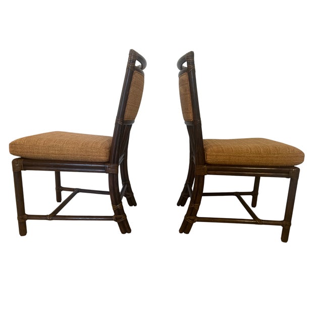 Stylish vintage dining set featuring a glass-top table paired with six matching chairs in a bamboo-style wood frame. The...