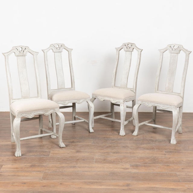 There is an understated elegance to this set of ten antique Swedish pine dining chairs in the graceful Rococo style. The...