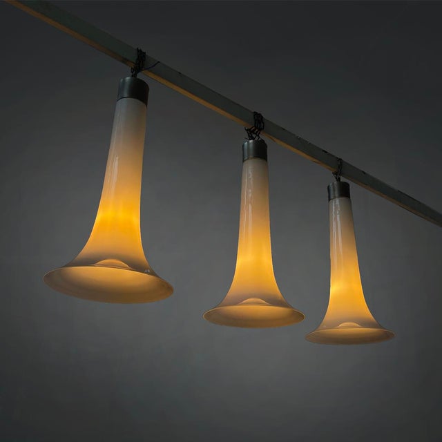 Italian modern chandeliers in white opaline glass and metal, 1970s Set of three white opaline glass pendant lamps. The...