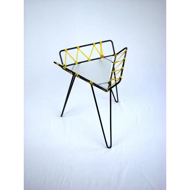 Petite, 33 cm high plant stand in the minimalist design of the 50s with a filigree tripod frame made of black-painted...