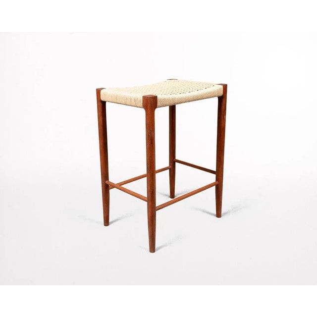 Papyri Stool in Walnut with Handwoven Danish Cord Featuring a mortice and tenon frame and handwoven seat, the Papyri Stool...