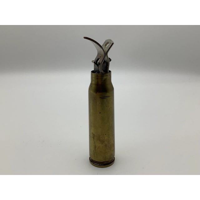 A cool vintage bullet shell that has been turned into a two-way bottle opener. The center is filled with what looks like...