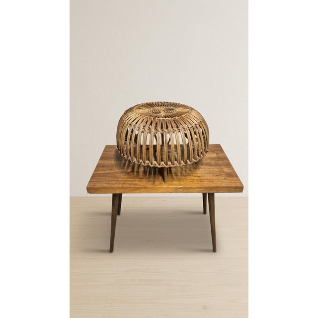 A distinctive mid-century woven rattan ottoman designed by Italian architect and designer Franco Albini, dating from the...