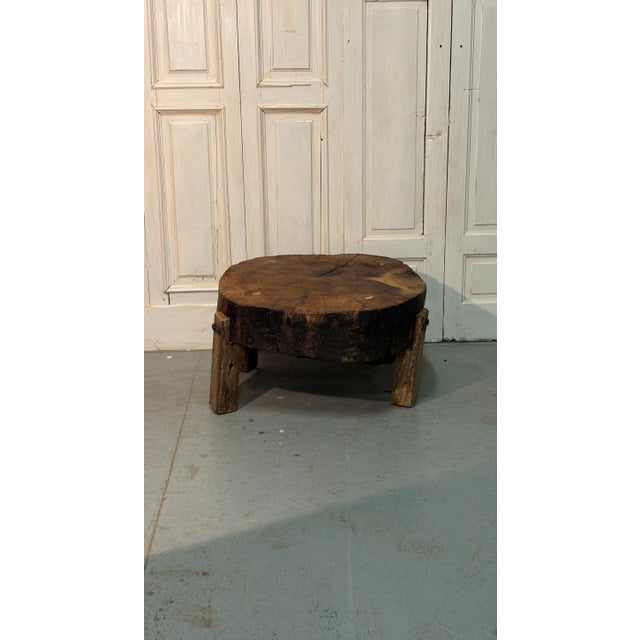 A rustic, Brutalist walnut coffee table from the early 20th century, characterized by its simple lines, solid structure,...