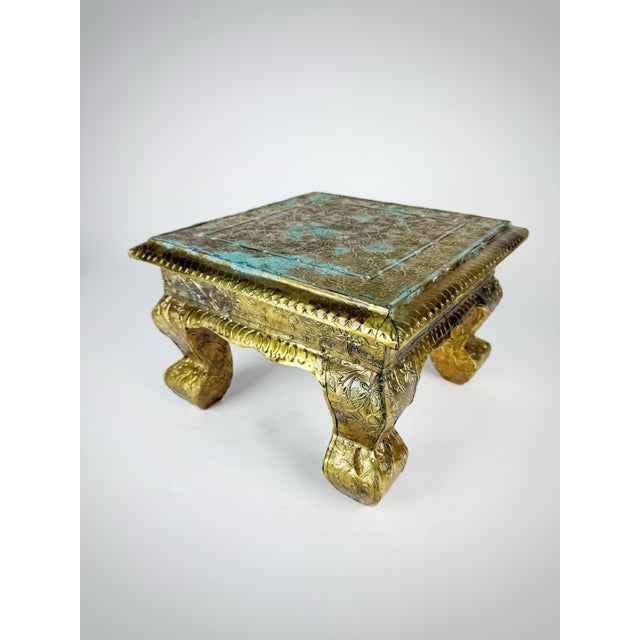 Bring warmth and old-world character to your home with this vintage brass-clad Anglo-Indian style chowki pedestal table....