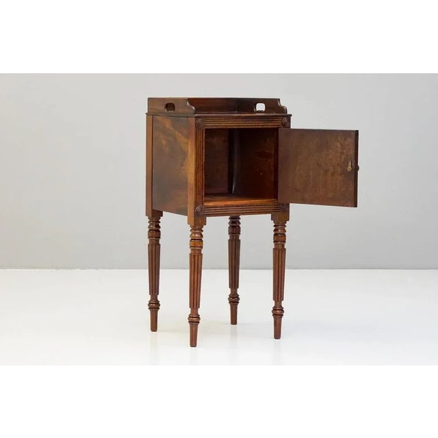 Single door mahogany bedside cupboard on receded legs.