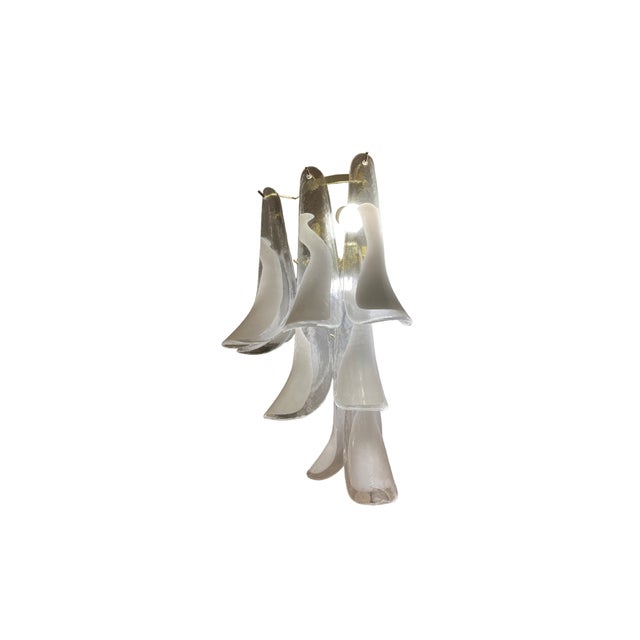 Pair of Murano glass wall sconces, Cala model in white. The semicircular, gilt brass frame has three levels, where the...