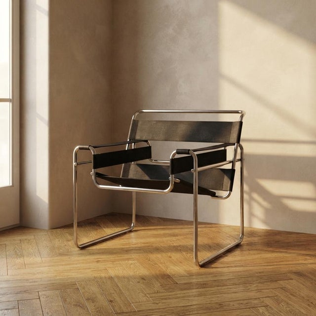 A vintage b3 wassily chair designed by marcel breuer, featuring a tubular chrome-plated steel frame and black leather...