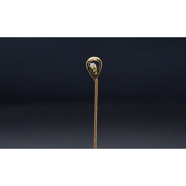 The Kenner: Yellow Gold Mid Century Lapel or Stick Pin. The pin features a central single cut round natural diamond center...