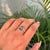 This Toi et Moi ring featuring a 1 carat of octagon emerald set in 14K white gold. The gemstones measure approximately...