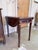 A finely detailed inlaid mahogany drop leaf table that carries a quiet sophistication through its proportions and...