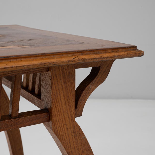 This 1900s French Art Nouveau wooden side table captures the movements characteristic fluidity and handcrafted elegance....