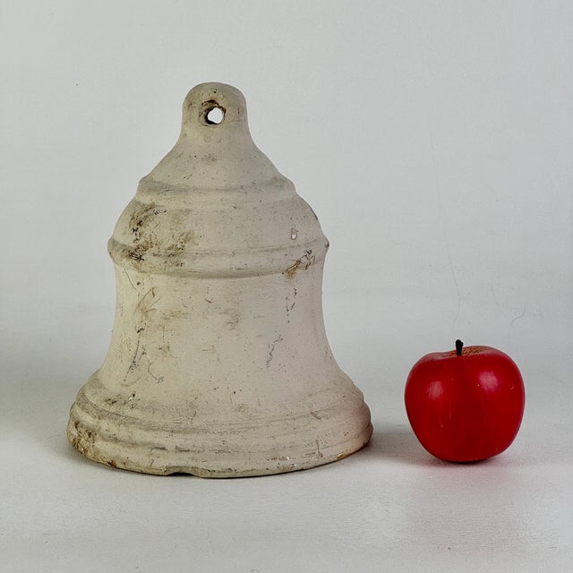 Ring the bell! A lovely vintage ceramic bell painted in antique white. A piece for indoor or outdoor use. Circa: Mid-Late...