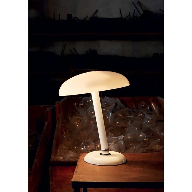 An adjustable table lamp in milk white Murano glass designed in 1978 by Carlo Moretti. Two x 60 watt incandescent bulbs,...