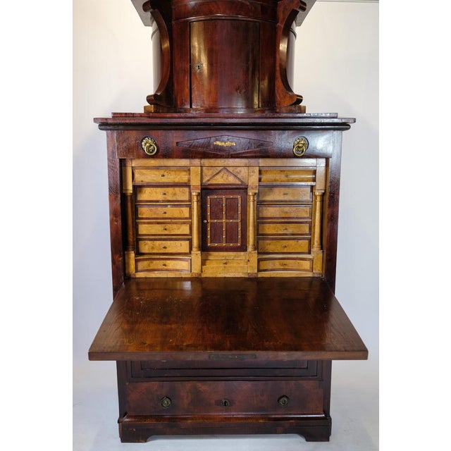 German secretary of patinated elm wood with top and brass fittings decorated with marquetry from Berlin around the 1840s....