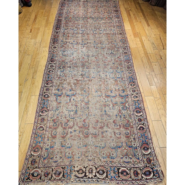 This exceptional mid-19th century Caucasian Karabagh gallery rug features one of the rarest and most coveted field colors...