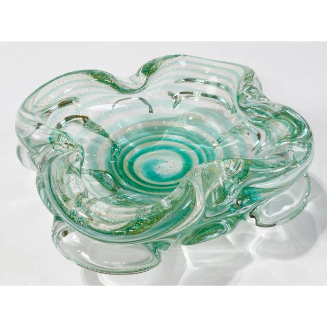 Beautiful vintage Murano style blown glass bowl featuring emerald green to vibrant turquoise swirls with golden splash to...