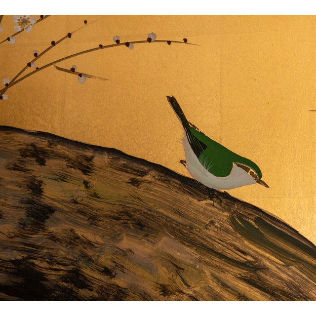 Titled by the artist. This screen depicts a plum tree on rivers edge with a solitary nightingale. Mineral pigments on gold...