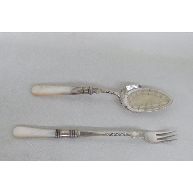 This lovely Fork and Spoon are made out of metal, and mother of pearl. The pieces have Victorian style and design. The...