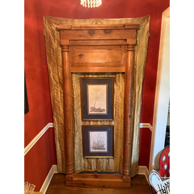 An exceptional antique overmantel mirror frame crafted from solid pine, featuring substantial turned columns, a deeply...