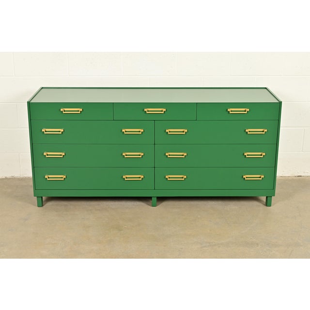 An exceptional mid-century modern Hollywood Regency Campaign style nine-drawer dresser or credenza By Michael Taylor for...