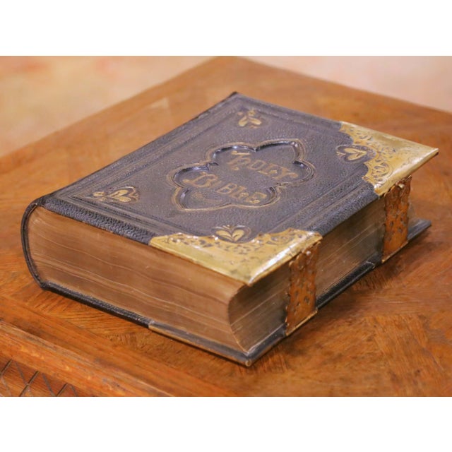 This impressive antique Holy Bible was published in the 19th century and bound in a richly embossed black leather cover...