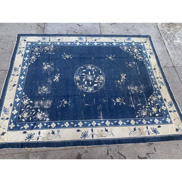 This handmade antique Chinese Peking rug from the early 1900s is a masterpiece of traditional craftsmanship. Featuring an...