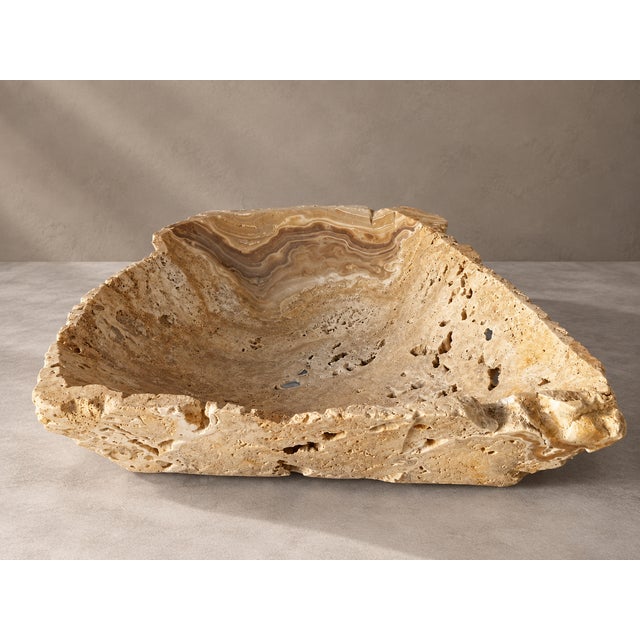 A striking antique onyx stone bowl, handcrafted into a sculptural decorative vessel that showcases the timeless beauty and...