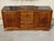Large solid walnut sideboard with straight, rectilinear curves. Three solid wood cupboard doors with a central motif and...