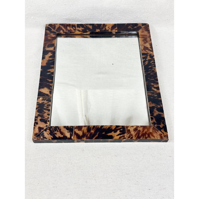 Fabulous vintage faux tortoise mirror. Made of wood. Wired to hang on the back, but can also be used with a stand. Makes a...