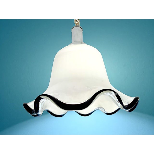 This elegant pendant light in the shape of a bell flower was made in Portugal in the 1960s-70s. The lamp is made of semi-...