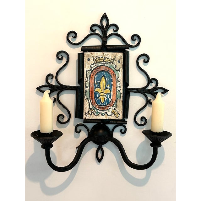 19th century French provincial tavern sconce. A brightly colored coat of arms is hand painted on a wooden plaque bordered...
