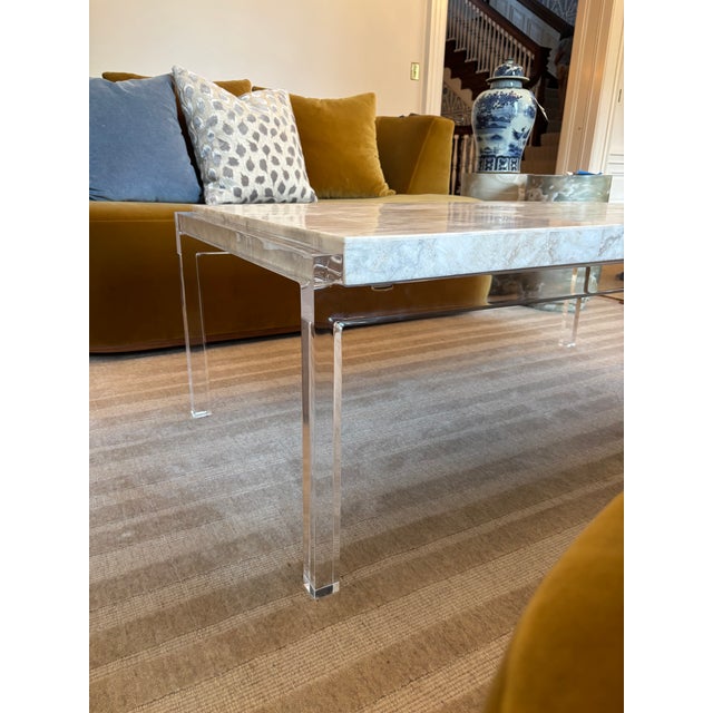 Acrylic legs and a beige crystal stone top make this a true statement piece for your sitting area. 48"L X 27"W X 19"H